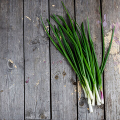 Pile of fresh spring onion on wood table