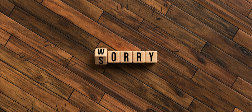 cubes with words SORRY and WORRY on wooden background