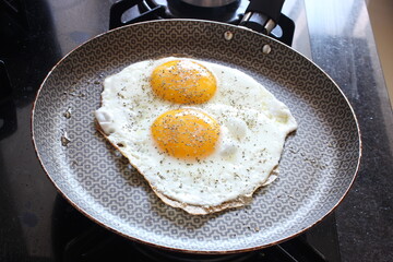 Fried Eggs with Oregano on Fridge Pan