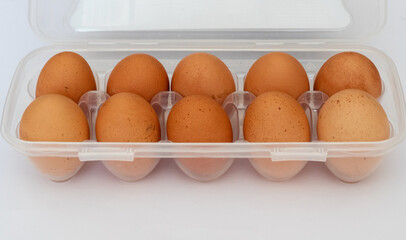 Rustic brown eggs in a plastic bag. Egg packaging on a white background. Packaging with Mockup