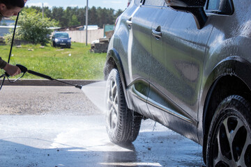 Washing a silver car on the first day of summer. The output from the isolation of coronavirus