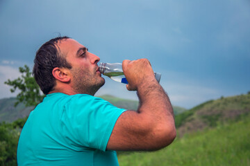man drink a water in nature