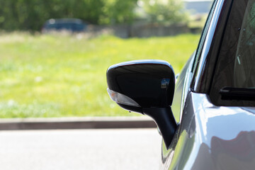 Close-up of the rearview mirror of a car with a turn signal repeater after washing