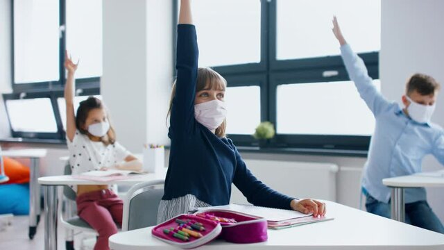 Group of children with face mask back at school after covid-19 quarantine and lockdown.