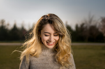 Smile in a natural way, portrait of a woman whose teeth appear when she smiles, the woman whose eyes are closed from happiness