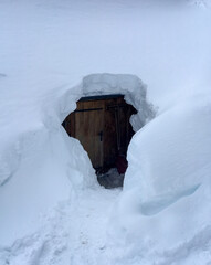 Door of snow covered mountain hut in the Austrian alps.
