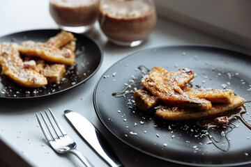 Fried Banana dessert and chocolate smoothie milk glass on white table. Selective focus