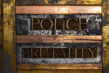 Photo of real authentic typeset letters forming Police Brutality text on vintage textured silver...