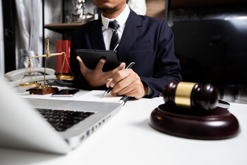 Concepts of Law and Legal services.	Lawyer businessman working with digital tablet at office.