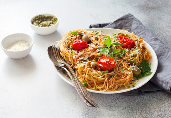 Pasta with tomato sauce, tomatoes and pesto close up