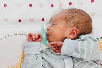 ten day beautiful infant girl sleeping peacefully with a pacifier