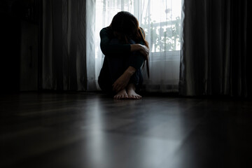 Sad young woman sitting on the bed in the bedroom, People with depression concept.	