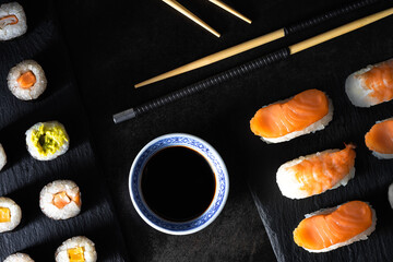 Healthy traditional japanese Sushi set nigiri and rolls with chopsticks.