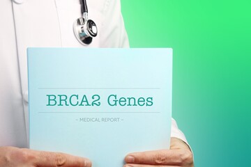 BRCA2 Genes. Doctor (male) with stethoscope holds medical report in his hands. Cutout. Green turquoise background. Text is on the documents. Healthcare/Medicine