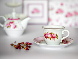 Top view of a cup of tea with dried roses
