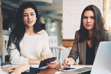 Modern three female colleagues brainstorming about work
