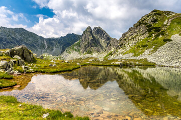 Mountain reflection into glacier lake from Retezat Mountains, Romania