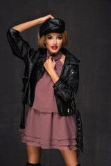 Sensual beautiful blonde woman posing in red dress. Girl with long curly hair.