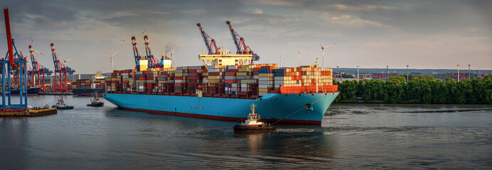 huge container ship at sunset in the port of Hamburg