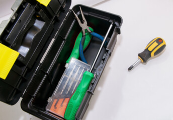 Screwdrivers and pliers are in the gray open tool box, next is another screwdriver