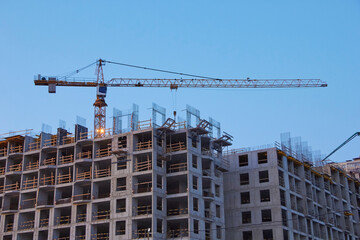 Fototapeta premium Industrial construction cranes the construction of an building