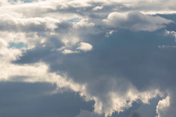 Detail of towering dramatic clouds in the Andean skies, stormy cloud formations laden with water about to precipitate, contrasted by the afternoon lights.