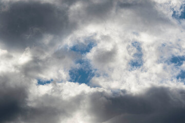 Detail of towering dramatic clouds in the Andean skies, stormy cloud formations laden with water about to precipitate, contrasted by the afternoon lights.