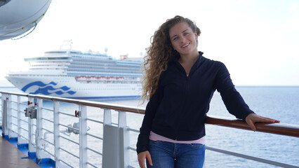 Girl circus gymnast performs a show on the air hoop. flexible acrobat spins on a ring in the air on a black background. slender young girl performs split in the air