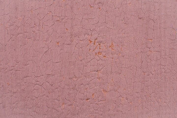 Peeling red paint on rusty metal wall. Close up pattern of rustic grunge material