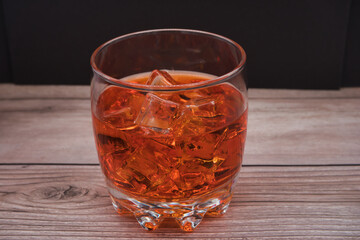 Glass cup with orange drink with ice