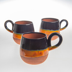 colorful handmade ceramic coffee cups on white background