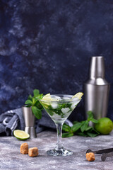 Martini cocktail with lime and mint.