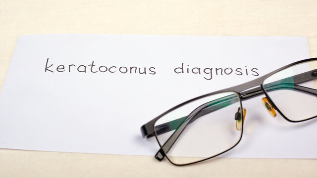 glasses for vision and the inscription diagnosis keratoconus on the table close-up. eye disease, diagnosis and treatment