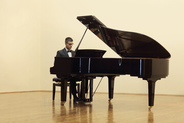 Pianist playing a grand piano in a salon