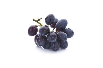 Dark blue grape with leaves isolated on white background.