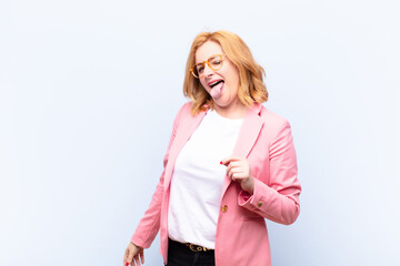 middle age woman with cheerful, carefree, rebellious attitude, joking and sticking tongue out, having fun