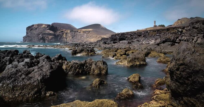 4k moving Timelapse Video clip of Capelinhos volcano cliff in Faial Island in Azores, Acores, Portugal. Turquoise sea at the foot of volcano with fast moving clouds.