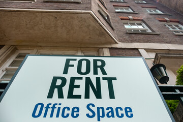 Obraz premium 'Offices For Rent' sign outside city building 