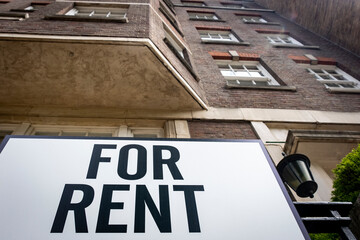 'For Rent' sign outside city building 
