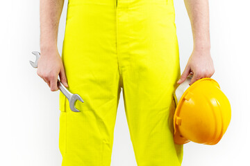 construction worker in yellow overalls, one hand protection helmet, wrench. engineering and technical service concept on white background.
