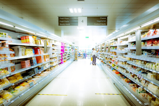 A bright abstract / blurred supermarket aisle with shelves full of food