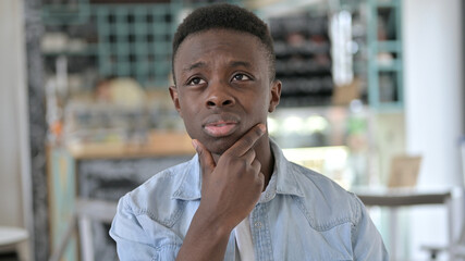 Portrait of Pensive Young African Man Thinking of New Idea