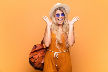  looking happy and excited, shocked with an unexpected surprise with both hands open next to face