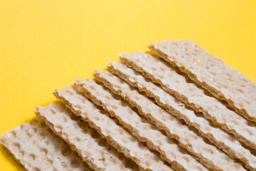crisps bread on a yellow background copy space
