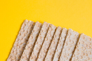 crisps bread on a yellow background copy space