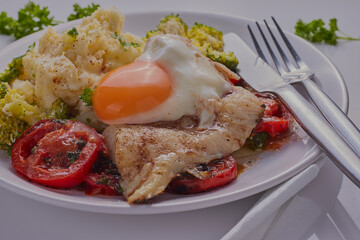 Cod fillet with poached egg,creamed potatoes and baked vegetables.