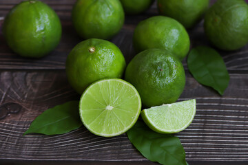 Natural fresh lime on wooden background.