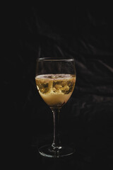 Sparkling wine in a cocktail, freshly served in a small glass, the foam and the gas can be perceived perfectly.