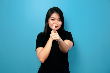 Portrait of Young beautiful asian women wearing black turtle neck shirt with blue isolated background