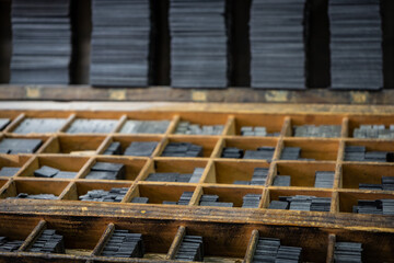 Printing press letter blocks in a wooden shelf. Printing industry